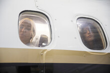 Women Looking Out Airplane Windows