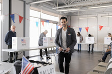 Man With Ballot Voting At American Polling Place