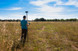 © Cavan Images - Surveyor working with a GPS instrument, taking data from the surface
