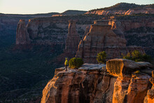 A Young Woman Enjoys A View Over Colorado National Monument In CO.