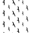 Vector seamless pattern of black seagull birds flock silhouette isolated on white background