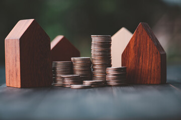 Investment in the real estate business. Money coin stack growing graph and wood house model. Loans for the purchase of residential houses.Save for the future.