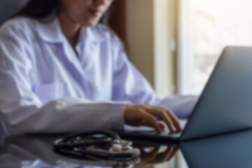 Wall Mural - young doctor woman working on laptop computer at office.