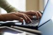 © NIKCOA - Blurred image of woman hands typing on laptop computer keyboard with digital tablet and stylus pen on the table at modern home office.
