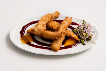 Breaded chicken dish on a white background