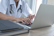 © tippapatt - Female doctor working on laptop computer in medical office
