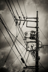 Tangle of electrical cables. Dangerous disorder of wires and transformers on an electric pylon.