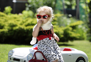 portrait of lovely little blonde girl with a white handkerchief