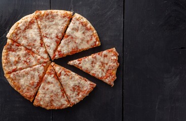 Sticker - High angle shot of pizza pieces on a wooden table background with a copy space