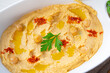 hummus paste with lemon and chilli on white background