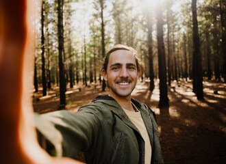 Self portrait of young happy male in the woods, selfie