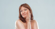 © Svyatoslav Lypynskyy - Pretty mature female applies skin care product by touching face with hand. Woman applying anti-age cream on her skin isolated on white background. Spa and wellness concept.