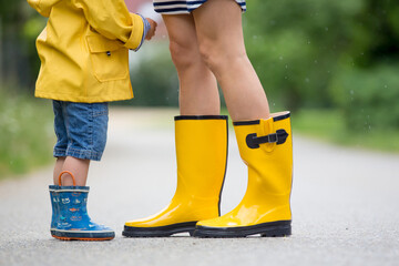 Sticker - Mother and toddler child, boy, playing in the rain