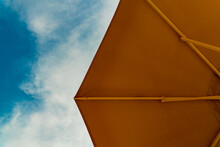 Looking Up To The Sky And Orange Sun Umbrella
