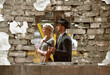 Two models get dressed up in 1930's style vintage 
clothing and act the part of the gangster duo 
Bonnie and Clyde. They are seen in the ruins of an 
old demolished factory.