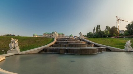 Poster - Belvedere palace with fountain and beautiful floral garden timelapse hyperlapse, Vienna Austria. Blue sky with clouds on sunny day. Green lawn and historic buildings