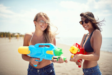 Wall Mural - Smiling  women having fun on the beach.Crazy vacation at the beach in summer holiday.