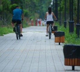 Blurred background. Two bicyclists in a recreation Park. Active life.