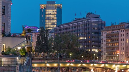 Wall Mural - Vienna cityscape with the Danube channel day to night transition timelapse in Vienna. Austria. Buildings with green trees and bridge with traffic