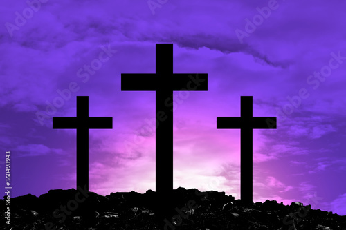 Fotografía Silhouette Cross Crucifixion Of Jesus Christ on the mountain with Dark purple background with white beams falling down, Easter concept