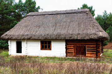 Wall Mural - Old traditional polish wooden house in an open-air museum of Kielce (Muzeum Wsi Kieleckiej), Tokarnia, Poland, Europe. Picture taken during famous polish golden autumn.