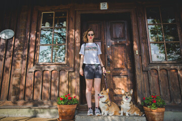 Wall Mural - happy welsh corgi pembroke dogs and a young woman owner