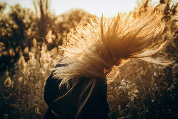 girl's hair develops in the wind autumn background picture