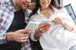© LIGHTFIELD STUDIOS - Cropped view of smiling woman pointing with finger at smartphone near boyfriend