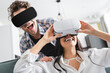 © LIGHTFIELD STUDIOS - Cheerful couple using virtual reality headsets at home