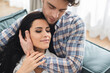 © LIGHTFIELD STUDIOS - Handsome man embracing beautiful woman with closed eyes on sofa