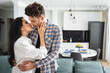 © LIGHTFIELD STUDIOS - Beautiful woman kissing and touching handsome man at home