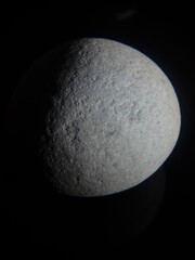 Poster - Round gray stone isolated on a black background