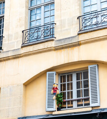 Paris, France, doll and flowers decoration in window with shutters