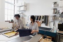 Women Preparing Printing Equiment In Studio