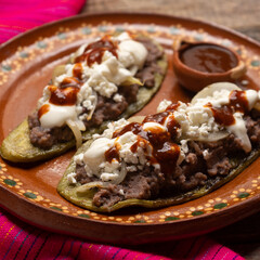 Wall Mural - Mexican nopal cactus huaraches with cheese and beans on wooden background