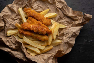 Wall Mural - British fish and chips on dark background