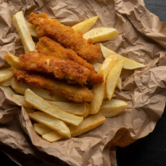 Wall Mural - British fish and chips on dark background