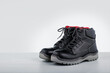 Industrial boots. Protective safety boots on grey surface. Copy space.