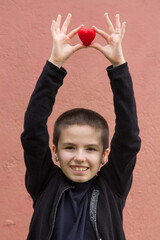 girl sick with cancer with red heart in her hands