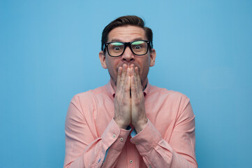 Wall Mural - Close-up portrait of shocked young man in glasses