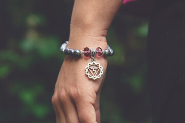 Wall Mural - Outboor closeup of hand wearing mineral stone bracelet