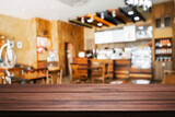 Fototapeta  - Empty wooden desk space and blurry background of restaurant vintage tone for product display montage