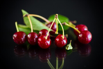 ripe red natural cherry on a black