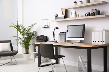 Modern computer on table in office interior. Stylish workplace