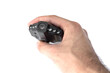 © Дмитрий Шкода - Male hand holds a black car DVR with a folding screen in the off state close up isolated on a white background