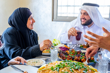 Wall Mural - Happy arabic muslim family enjoying the food togther in ramadan