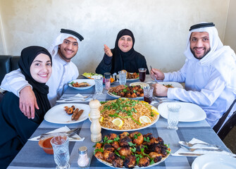 Wall Mural - Happy arabic muslim family enjoying the food togther in ramadan