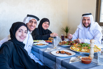 Wall Mural - Happy arabic muslim family enjoying the food togther in ramadan