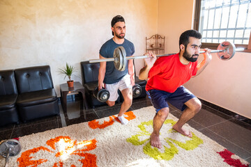 Wall Mural - Two brothers weight lifting and doing sports together at home