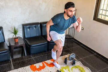 Wall Mural - Guy doing some training at home to keep in good shape